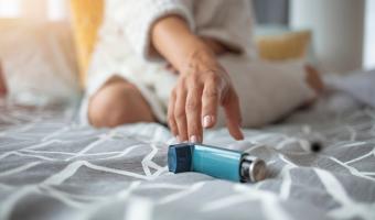 person reaching for inhaler