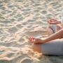 A woman is peacefully sitting in a traditional lotus position