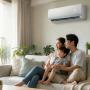 Asian couple enjoying their inverter air conditioner at home Air conditioner should be visible and the main highlight. Remove air lines Smiling and not directly looking at the camera
